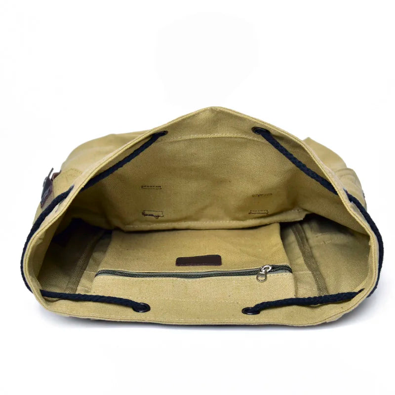 Beige ryggsäck canvas dam med flera fickor, perfekt för outdoor-aktiviteter och vandring.