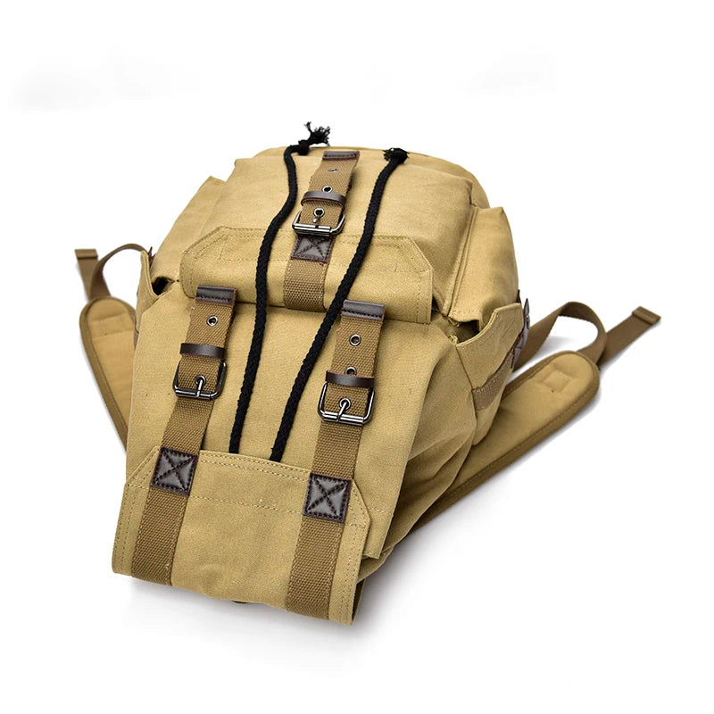 Beige ryggsäck canvas dam i retrostil, idealisk för resor, skola eller jobb.
